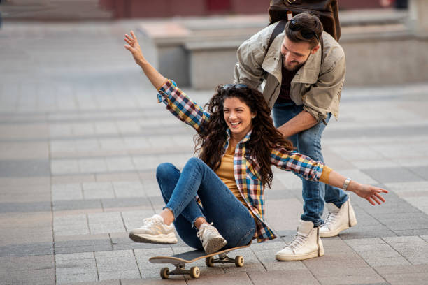 istock Happy couple having fun with skateboard 1401611760