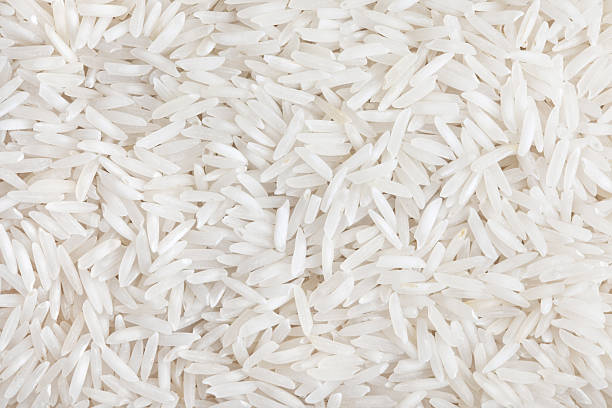 Rice (long grain) Rice white long-grain texture background. Indian basmati rise. rice food staple photos stock pictures, royalty-free photos & images