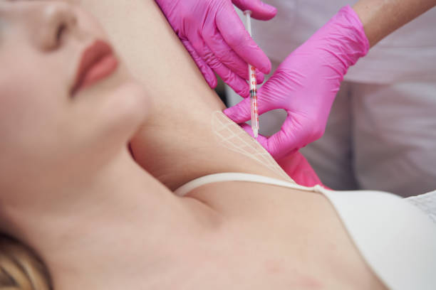 istock Female client is getting armpit injections to prevent excessive sweating in beauty center 1401615737