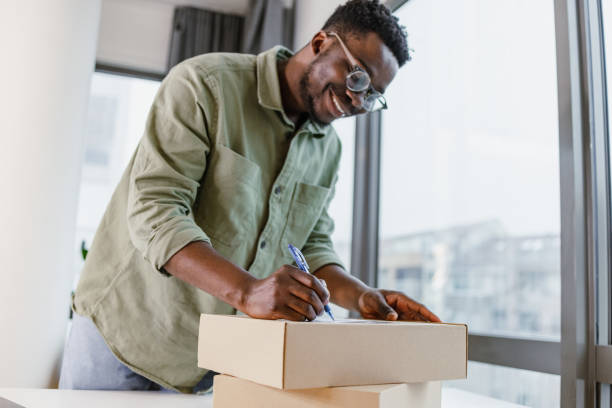istock Young man preparing and packing online orders for his customers 1401620879