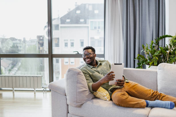 istock African-American man using digital tablet at home 1401621015