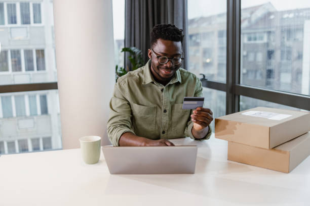 istock Young man using laptop and credit card for e-commerce 1401621156