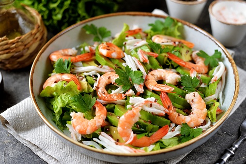 Healthy salad of shrimp, snow crab, avocado, flaxseed, lettuce, olive oil and lemon juice