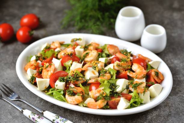 Salad with shrimps, mozzarella, cherry tomatoes stock photo