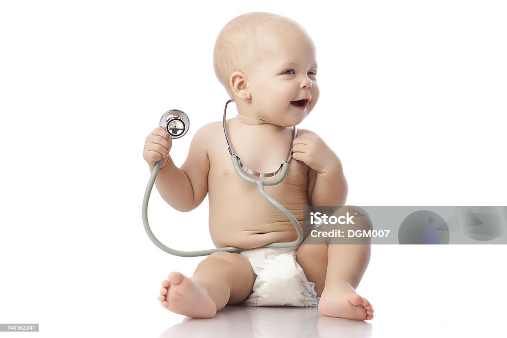 Baby with stethoscope. Sweet baby with stethoscope on a  white background. 12-17 Months Stock Photo