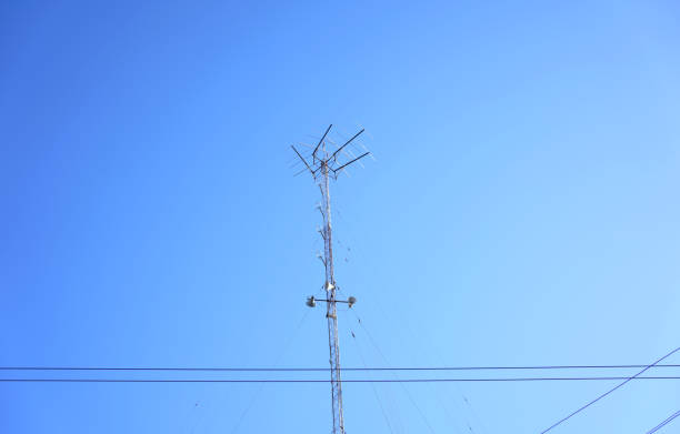 istock Radio receiver antenna on blue sky background. 1401628908