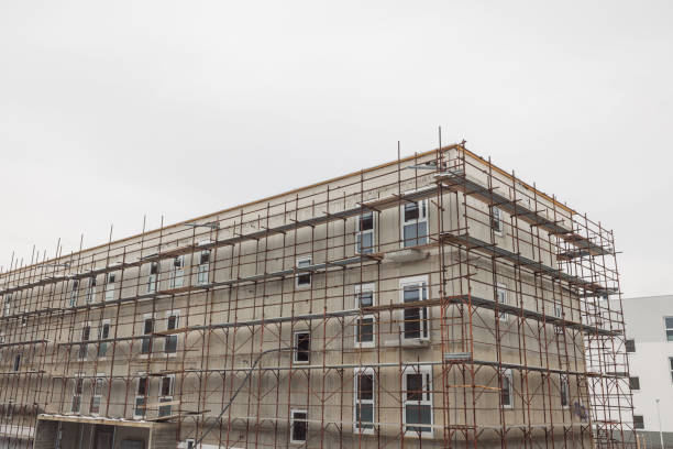 Construction site of apartment complex in the residential area, ready for facade. Finishing the exterior of new construction.