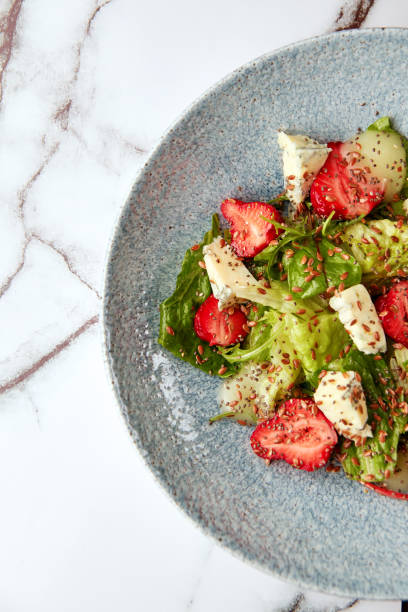 istock Bright salad with strawberry, spinach and blue cheese. 1401630100