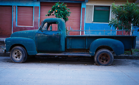 Old truck in front of the house.