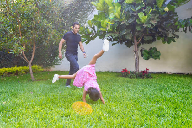 istock Little girl doing cartwheels 1401636642