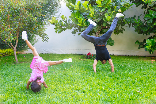 dad and daughter doing cartwheels