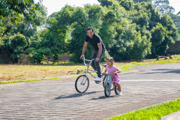 istock father and daughter riding their bicycles 1401637270
