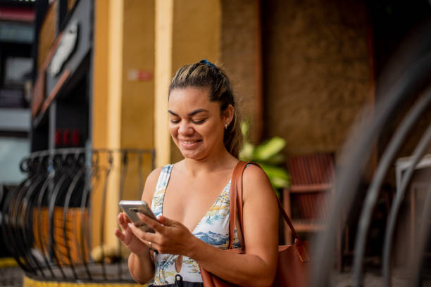 istock Tourist woman using cellphone in the city 1401637611