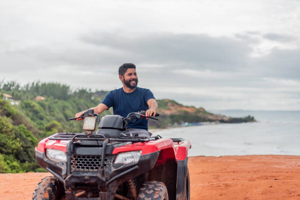 istock Man contemplating the view on his ATV 1401637629