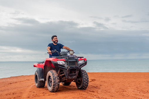 Man contemplating the view on his ATV