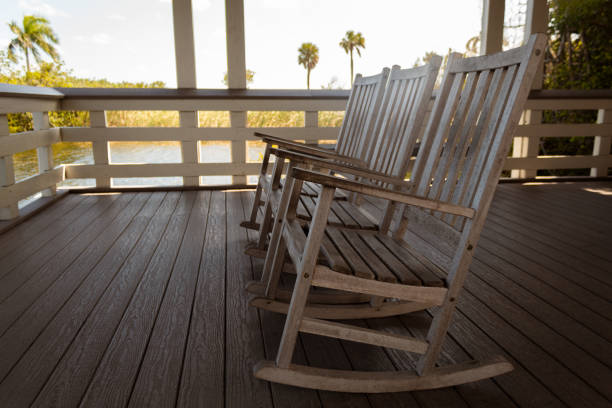 istock Three wooden rocking chairs in a log cabin 1401639176
