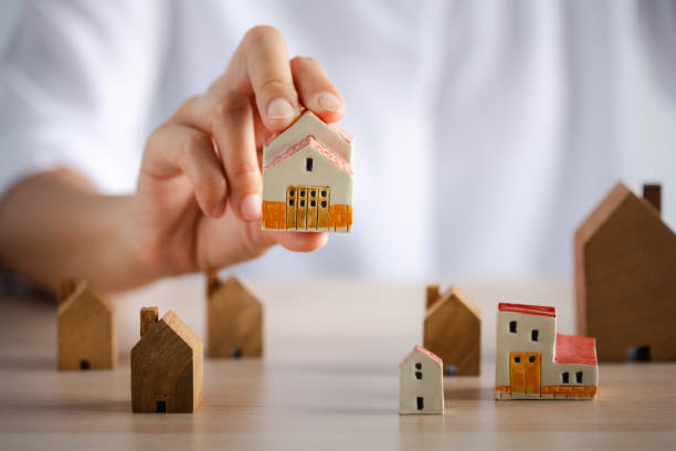 istock closeup woman hand holding beautiful home model 1401639469