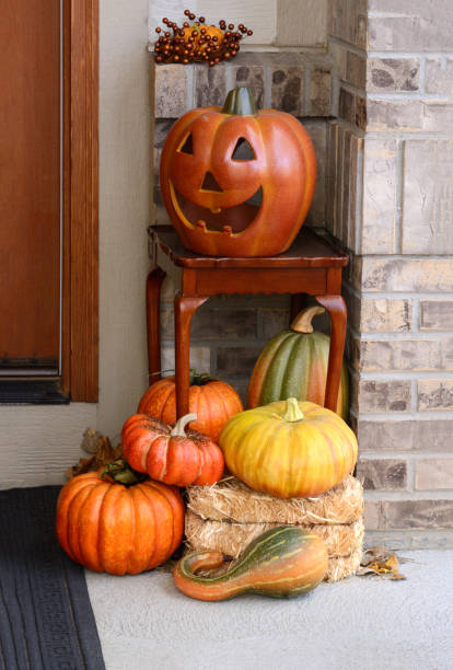 istock Jack o'lantern on table and harvest of pumpkins and squash 1401642056