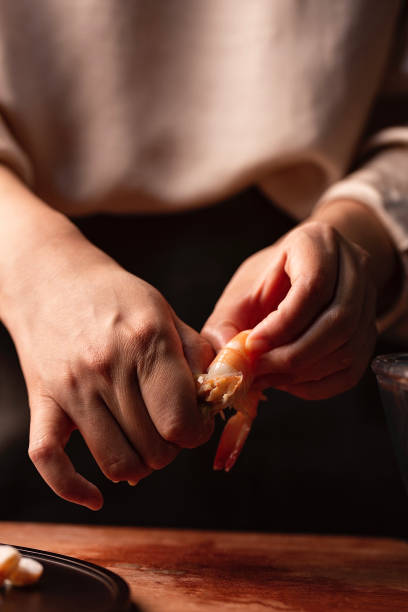 istock Chinese traditional cuisine three fresh dumplings filling preparation, remove the shell of shrimp - stock photo 1401645145