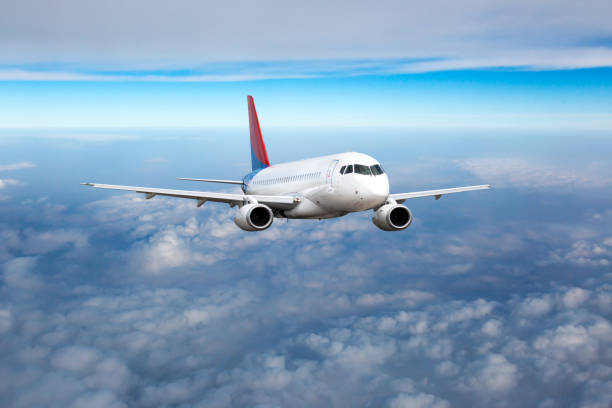 istock Front view of the passenger plane flies above the clouds 1401646133