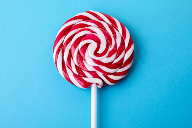 istock Red and white lollipop on a blue background 1401650781