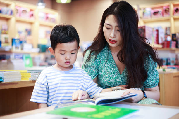 istock Mother and son reading together in a bookstore 1401650916