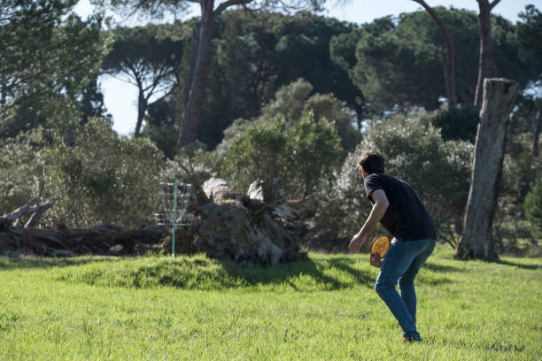 istock Disk golfer takes a shot towards the disk cage 1401655738