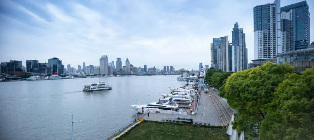 Lujiazui building complex and boats stopping along the Huangpu River