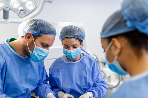 Shot of a team of surgeons performing a surgery in an operating theatre
