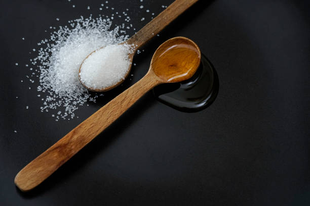 istock Honey vs sugar, isolated on a black 1401661120