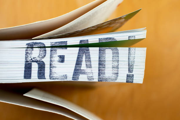 READ! written with stamp lettering on the side of a   book