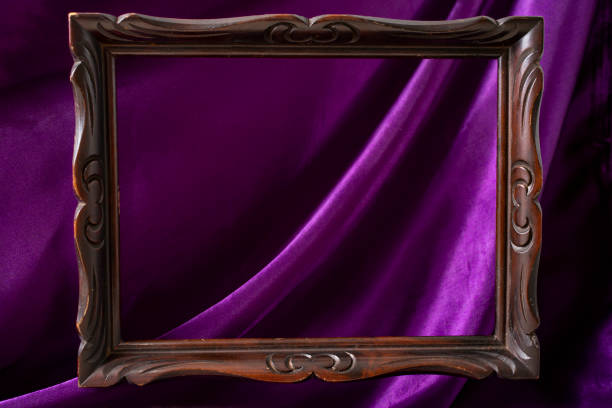 istock levitating wooden frame on purple satin background 1401663084