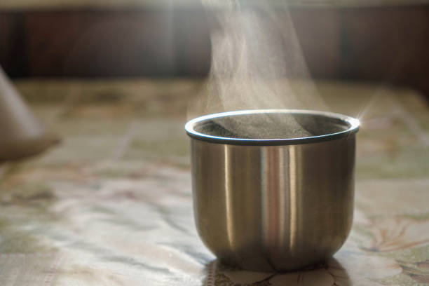 istock Thermos cup with steaming hot coffee or tea on a cold sunny morning. 1401663157