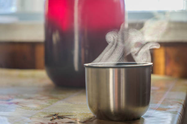 istock Evaporation. Hot steaming thermos cup on the table on a cold sunny day. 1401663182