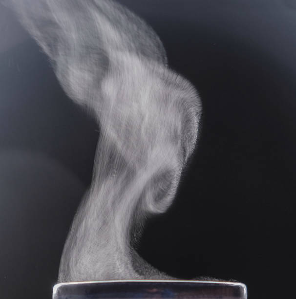 istock Steam rising from a mug. Liquid evaporation. Dark photo. 1401664844