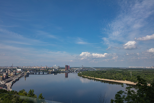 Kyiv, Ukraine - June 1, 2022: View on Dnipro river from pedestrian and bicycle bridge across Saint Volodymyr descent  in Kyiv, Ukraine