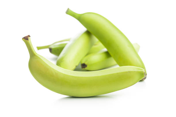 Unripe green bananas isolated on a white background.