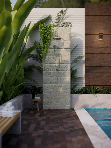 Stunning outdoor shower in the tropical green garden by the pool in luxury pool villa Stunning outdoor shower in the tropical green garden by the pool in luxury pool villa or luxury house exterior design. 3d rendering, 3d illustration raining outside stock pictures, royalty-free photos & images