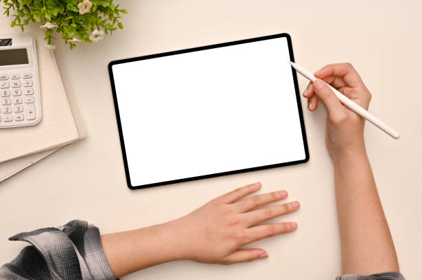 istock Above view, A female using stylus pen, drawing on tablet screen in her modern office desk. 1401669339