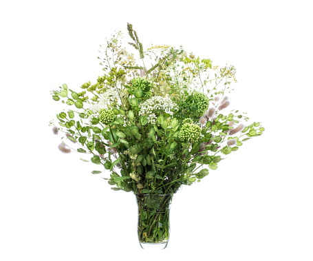 Bouquet of various wildflowers in a glass vase with water