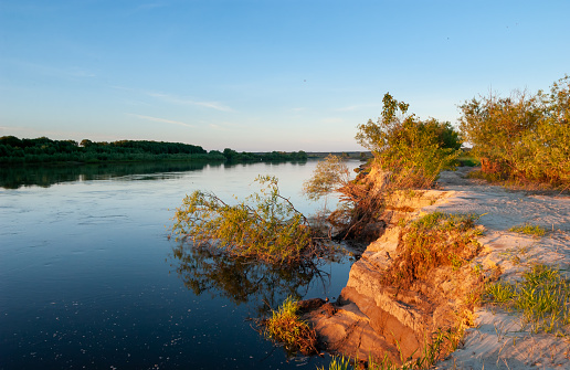 The picturesque river bank, The current destroys the sandy shores. Oka River, Ryazan region, Russia.