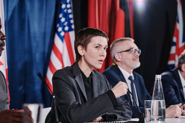 istock Speaker sitting at political meeting 1401671398
