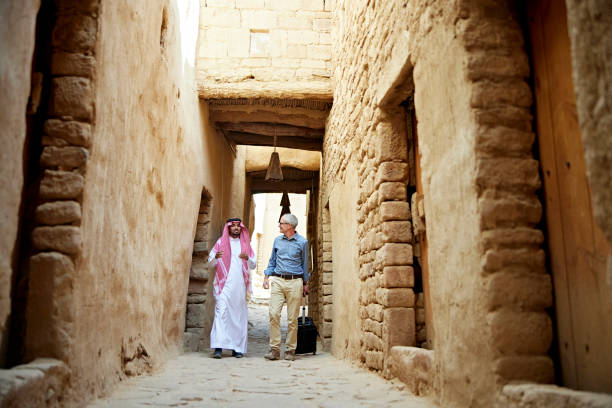 istock Saudi guide and business traveler visiting historic district 1401671522