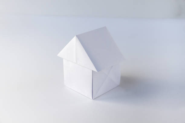 istock Paper house origami isolated on a white background 1401672633