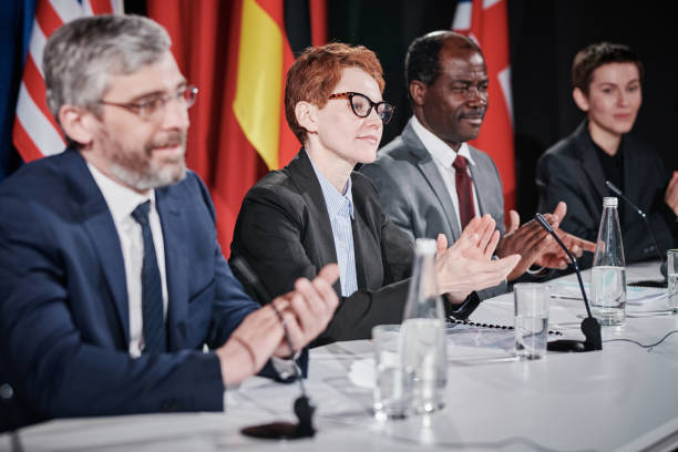 istock Group of politicians clapping at conference 1401673975
