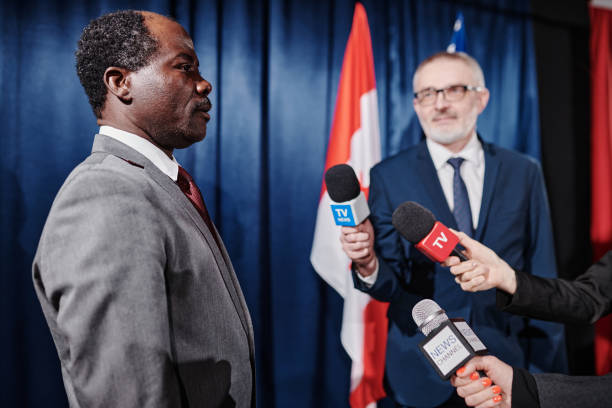 istock Politician being interviewed by journalists 1401674192