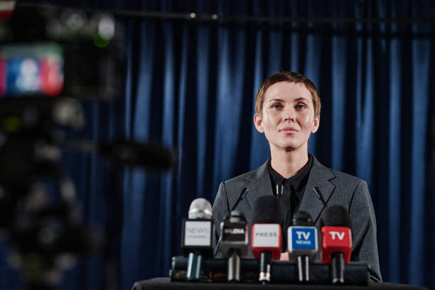 Woman performing at conference during live broadcast