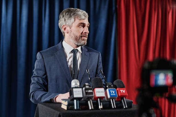 istock Businessman giving an interview at conference 1401674385