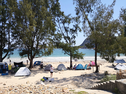 People camping at the beautiful Pak Lap Wan beach in Sai Kung peninsula, Hong Kong.