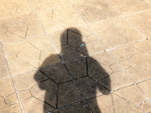 istock Take a shadow of yourself on the road Shadows against sunlight create a dark shape. showing different surfaces 1401675300